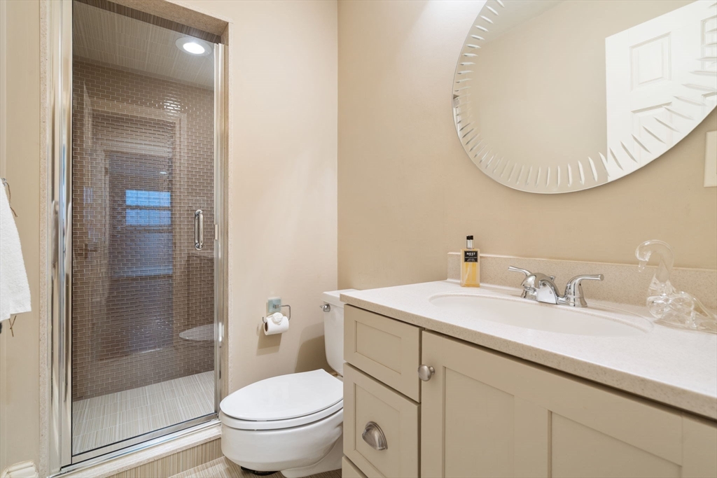 11 Hillcrest Road Weston, MA 02493 - Photo 34 of 42 a bathroom with a toilet a sink a mirror and vanity