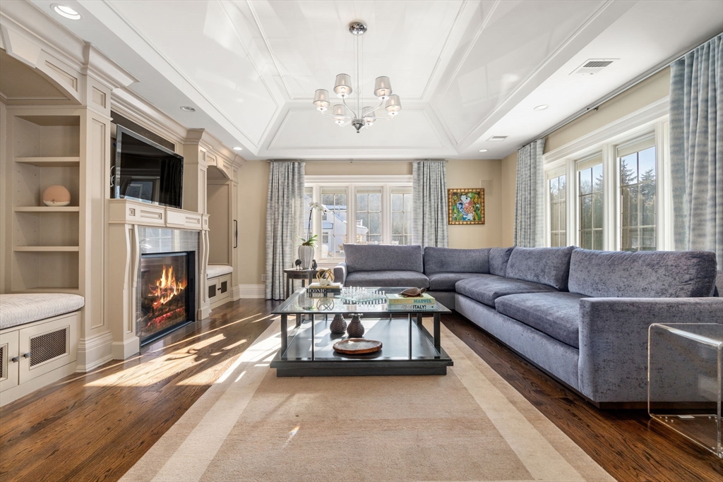 11 Hillcrest Road Weston, MA 02493 - Photo 5 of 42 a living room with furniture a fireplace and a flat screen tv