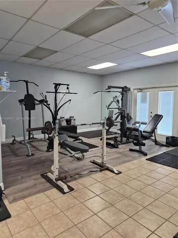 a room with pool table and windows