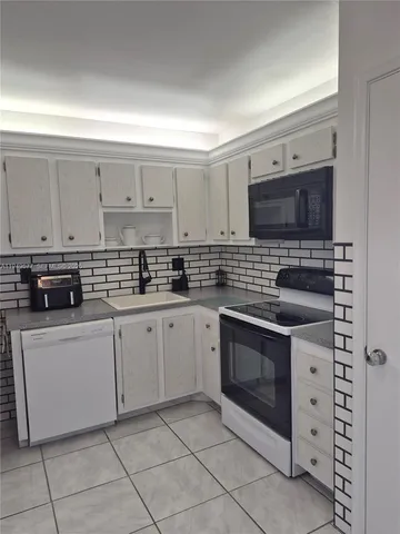 a kitchen with stainless steel appliances a stove and a microwave