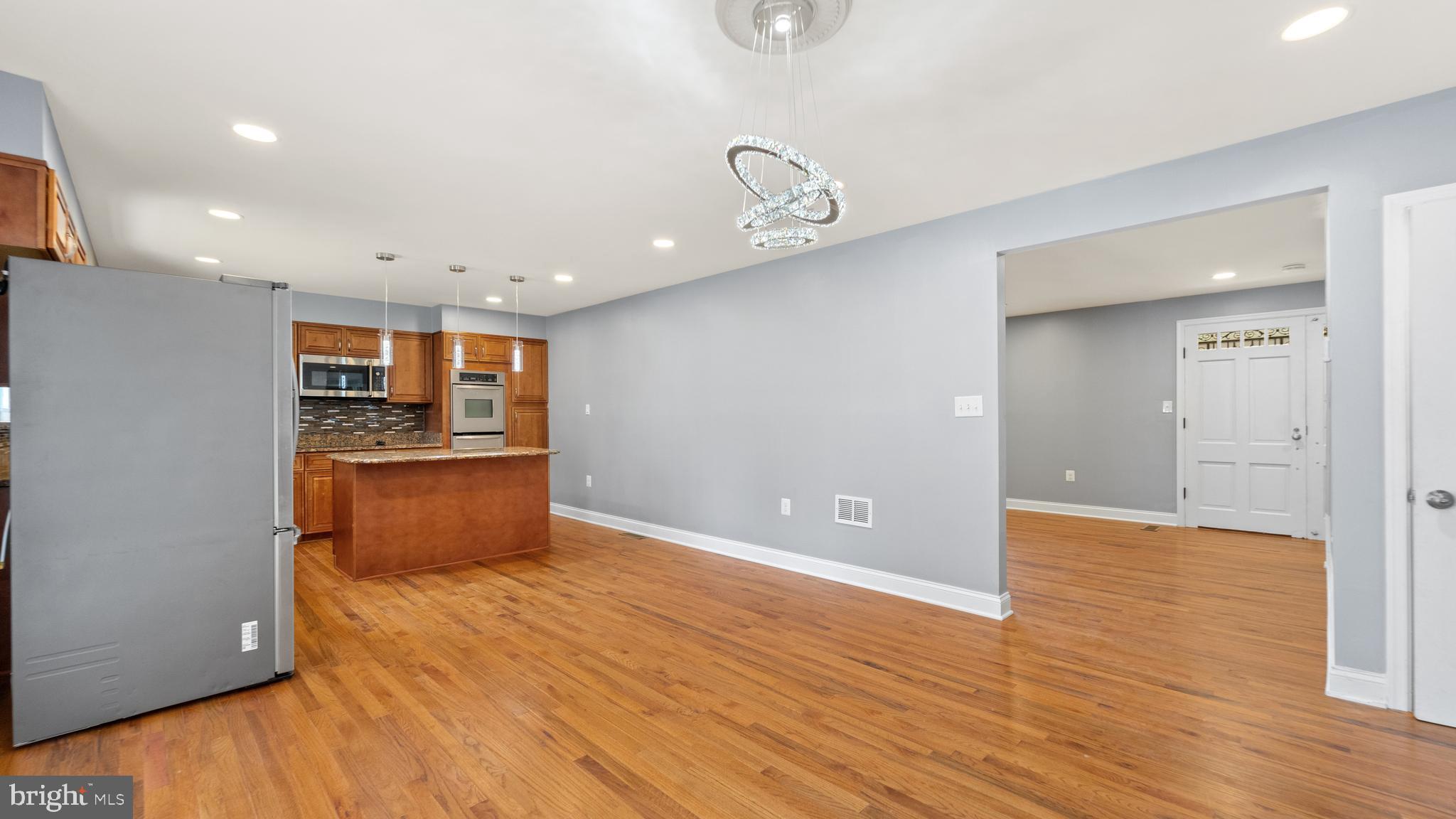3605 Chapman Road Randallstown, MD 21133 - Photo 7 of 65 a view of kitchen and empty room with wooden floor