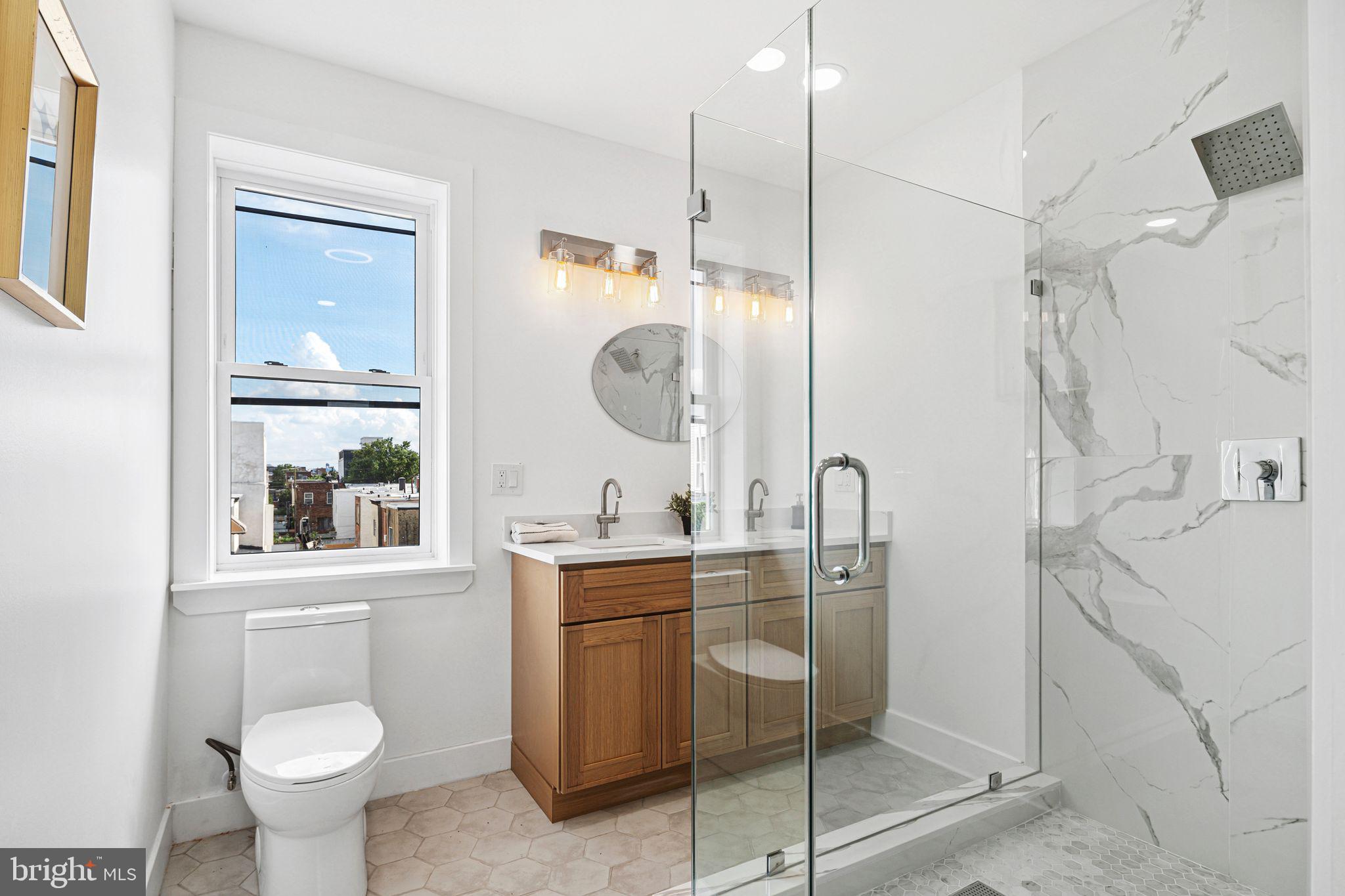 908 Reed Street Philadelphia, PA 19147 - Photo 15 of 31 a bathroom with a toilet sink and mirror