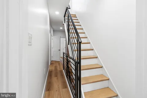 a view of a hallway with wooden floor and entryway