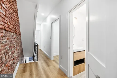 a view of hallway with stairs and a wooden floor