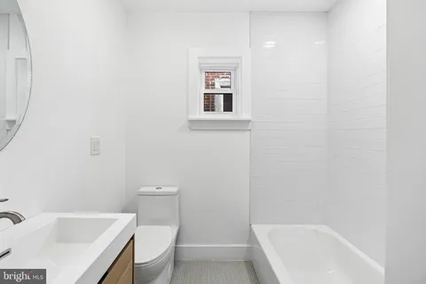 a bathroom with a toilet a sink and bathtub