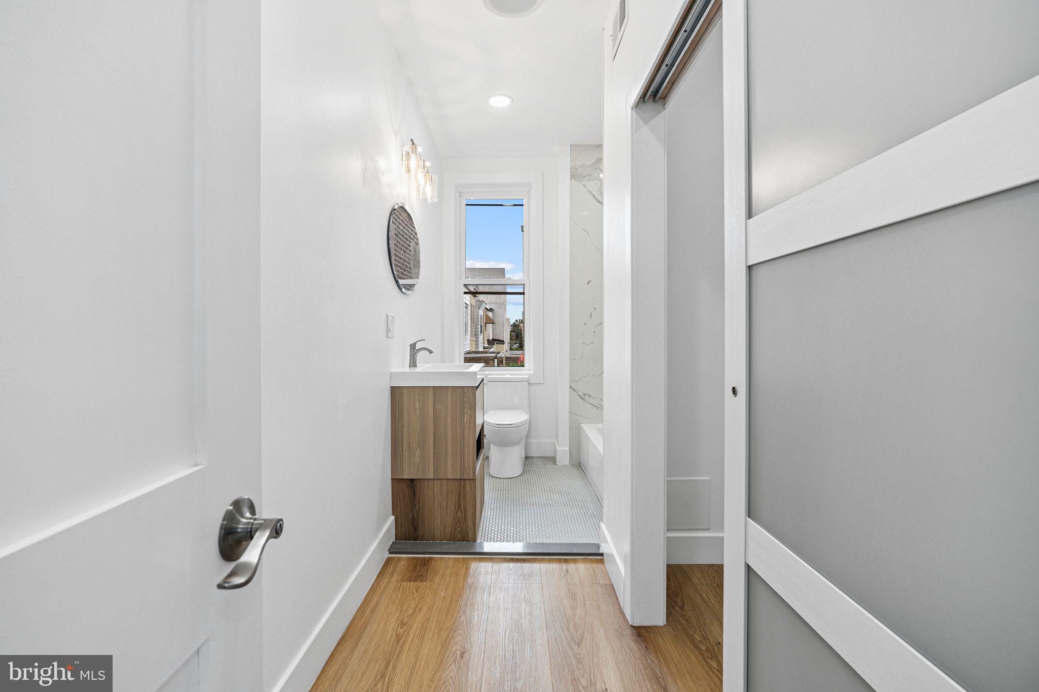 908 Reed Street Philadelphia, PA 19147 - Photo 25 of 31 a bathroom with a sink a mirror and shower