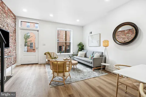 a living room with furniture a window and a flat screen tv