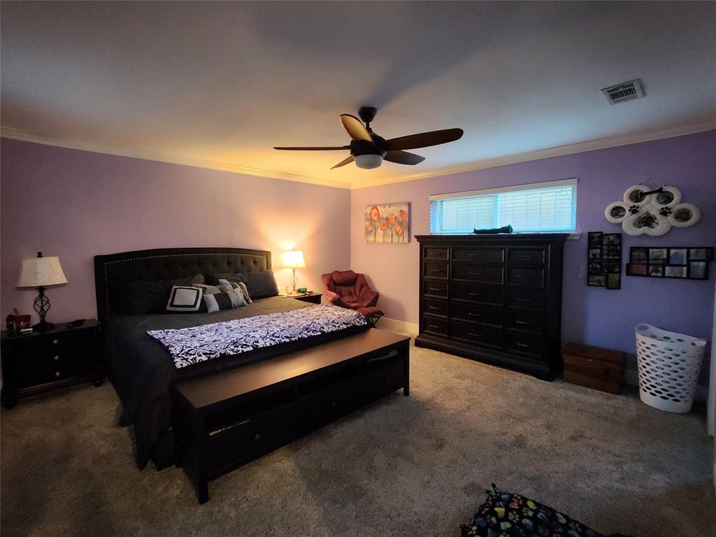 1023 Ridgefield Drive Plano, TX 75075 - Photo 27 of 39 a bedroom with a bed and a chandelier