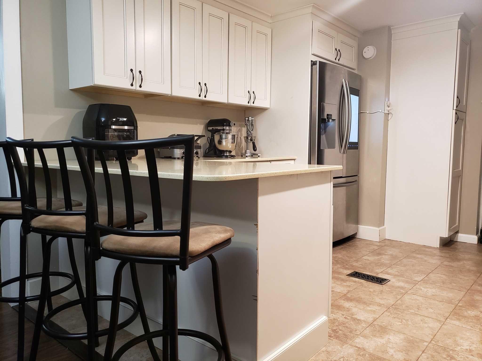 413 Cologne Avenue Wallkill, NY 12589 - Photo 3 of 22 a kitchen with a table chairs refrigerator and cabinets