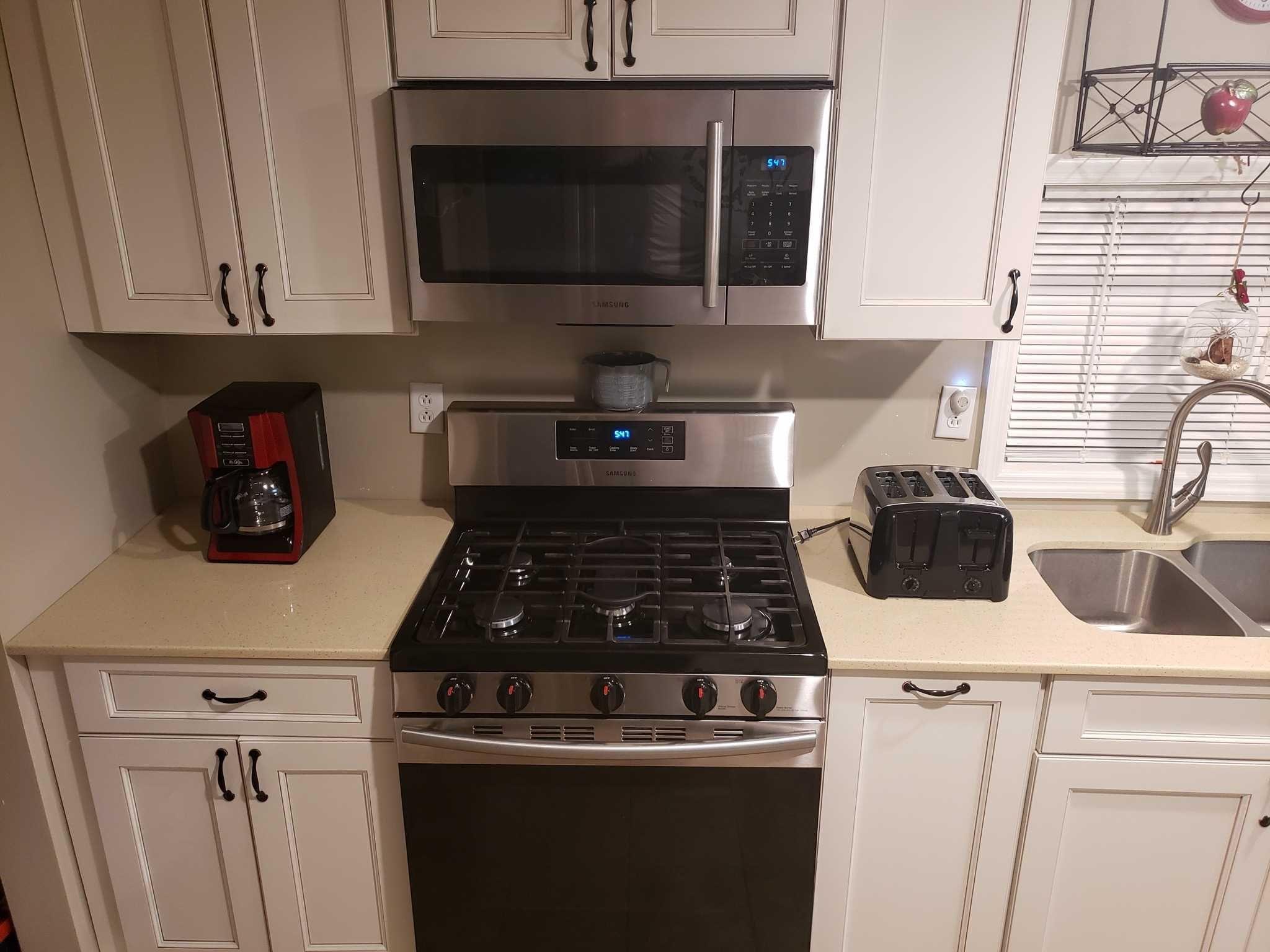 413 Cologne Avenue Wallkill, NY 12589 - Photo 4 of 22 a kitchen with a stove and a microwave