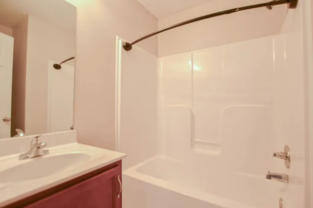 a bathroom with a bathtub and a sink