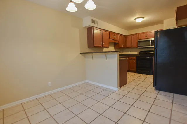 a kitchen with a refrigerator and a stove