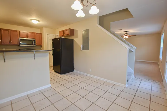 a kitchen with stainless steel appliances granite countertop a refrigerator and a sink