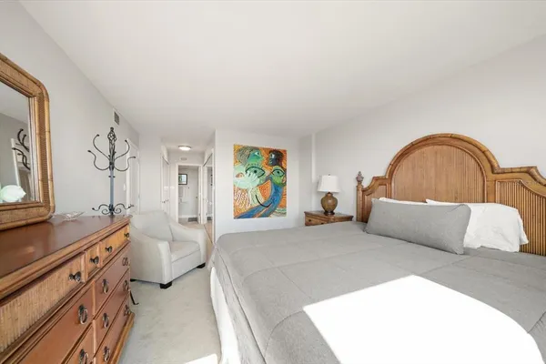 a bedroom with a bed and a dresser