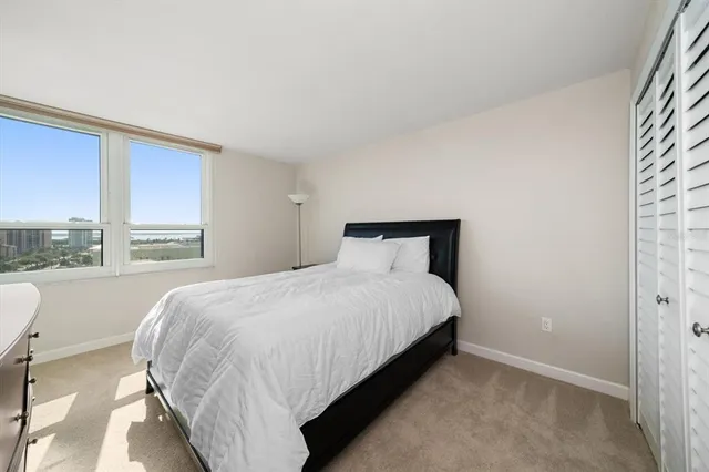 a bedroom with a bed and window