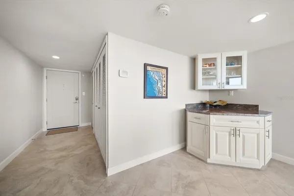 a view of kitchen with granite countertop cabinets