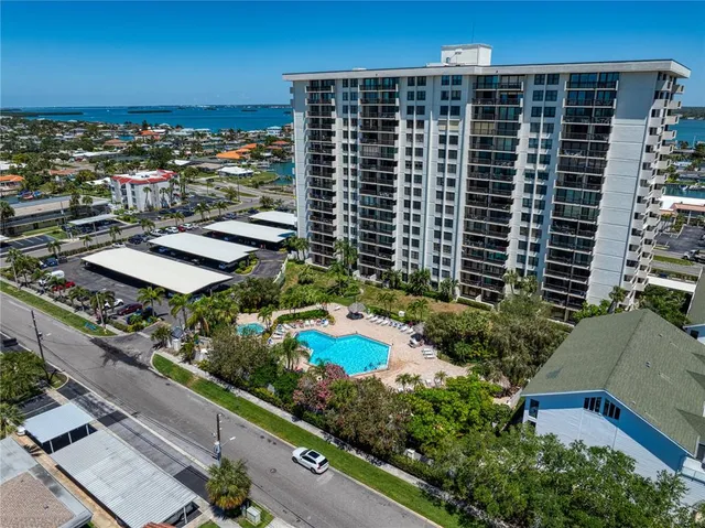 an aerial view of a residential apartment building with a yard