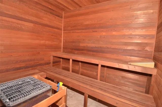 a view of a balcony with wooden floor and a floor to ceiling window