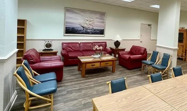 a living room with furniture a rug and white walls