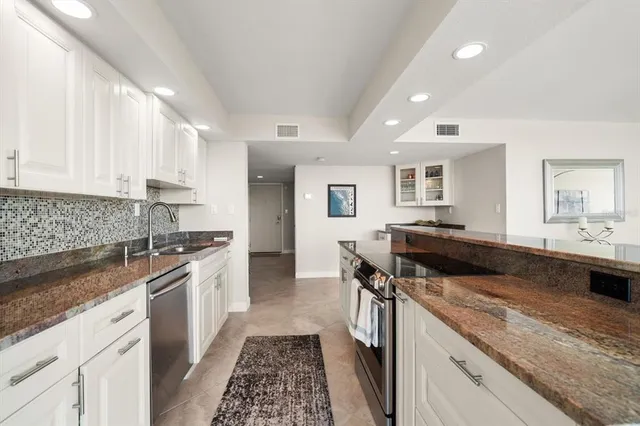 a kitchen with a stove and a sink