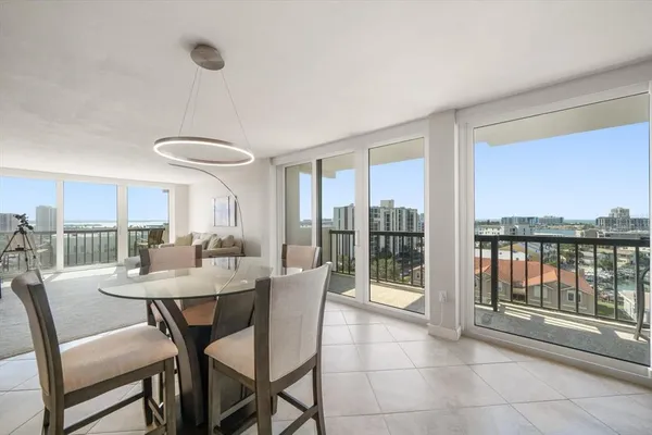 a view of a dining room with furniture large windows and wooden floor