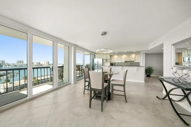 a dining room with furniture and large windows