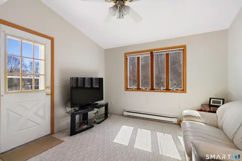 a living room with a flat screen tv and a window