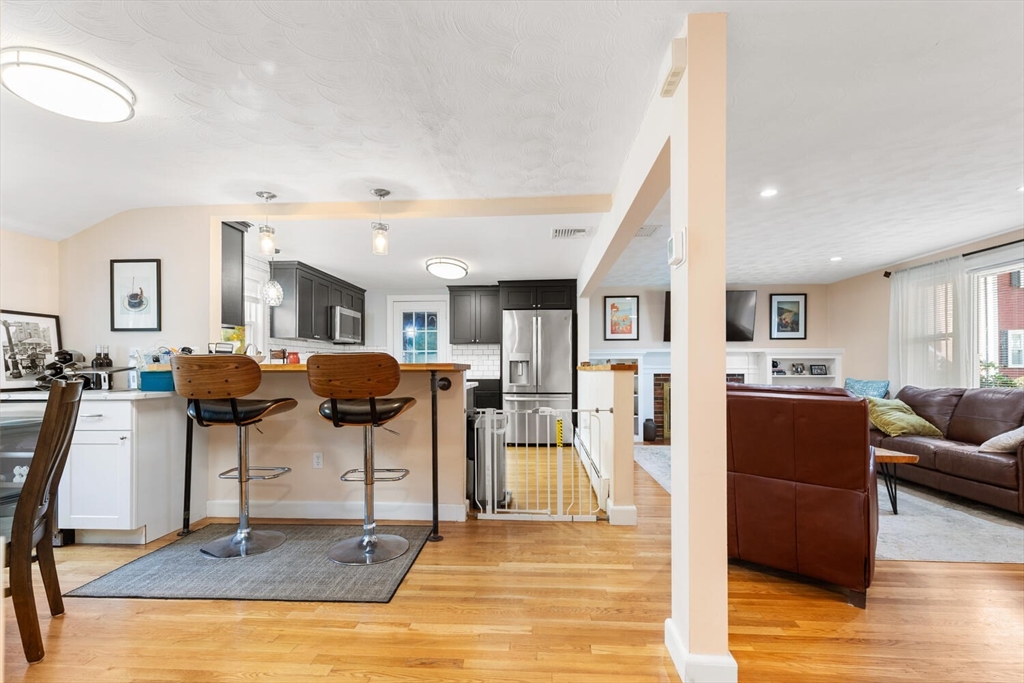 22 Wayland Road Wakefield, MA 01880 - Photo 13 of 28 a living room with furniture and a wooden floor