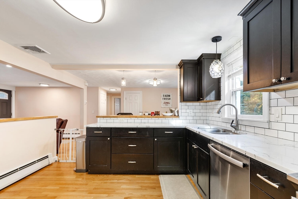 22 Wayland Road Wakefield, MA 01880 - Photo 17 of 28 a kitchen with a sink and a refrigerator