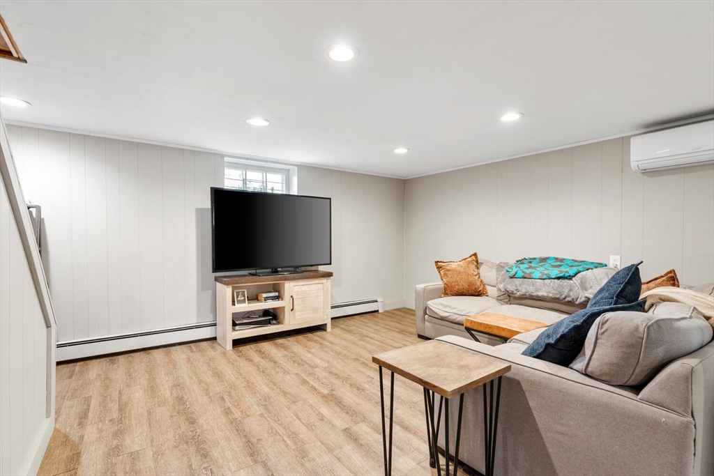 22 Wayland Road Wakefield, MA 01880 - Photo 25 of 28 a living room with furniture and a flat screen tv