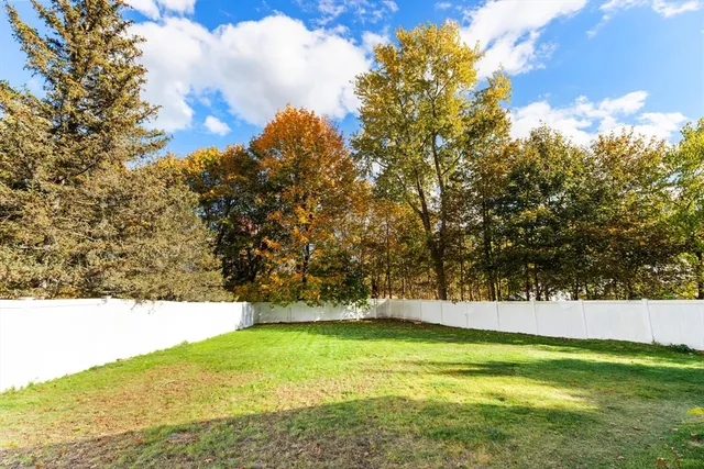 a view of yard with swimming pool and trees