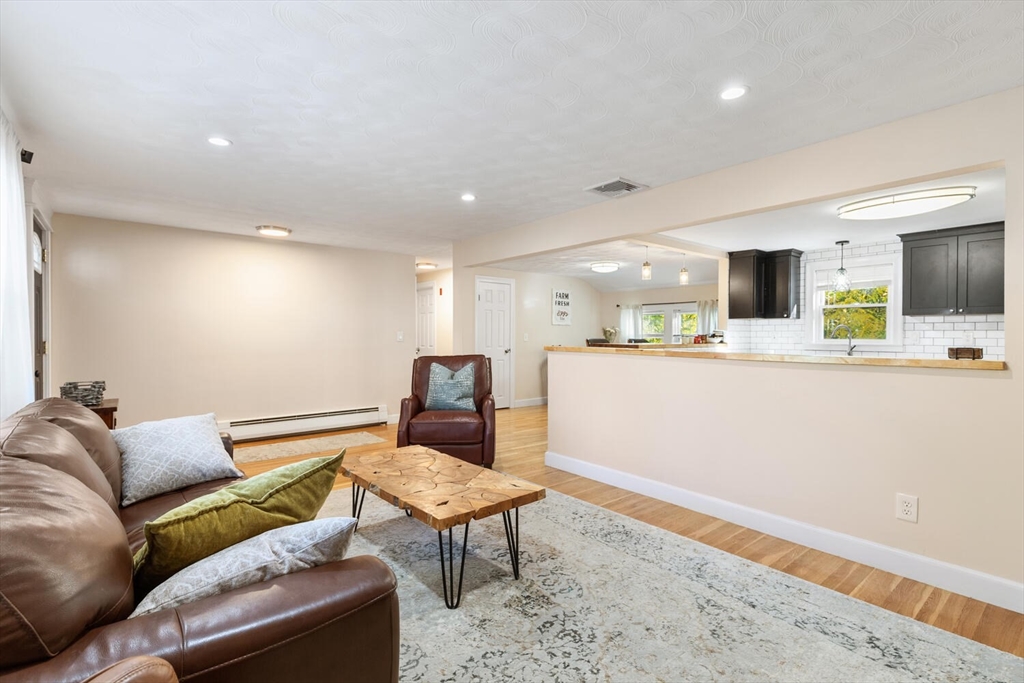 22 Wayland Road Wakefield, MA 01880 - Photo 9 of 28 a living room with furniture and a wooden floor