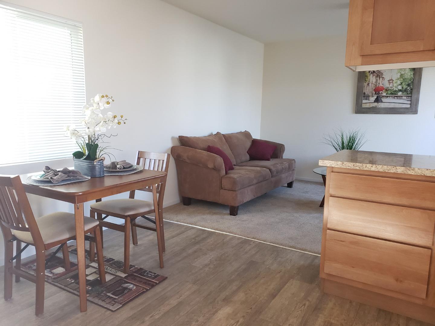 55 San Juan Grade Road, Unit 49 Salinas, CA 93906 - Photo 4 of 14 a living room with furniture and a dining table with chair