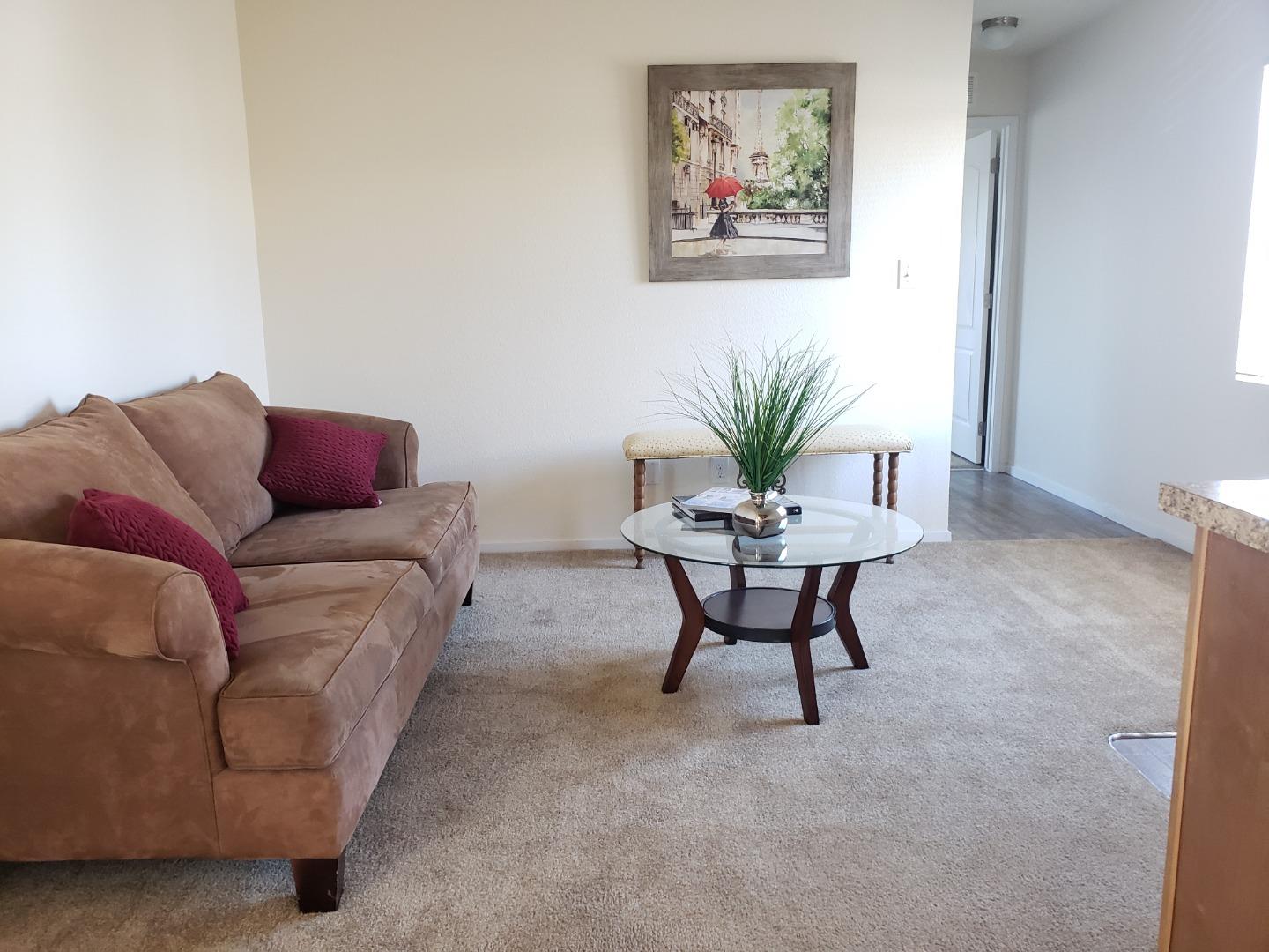 55 San Juan Grade Road, Unit 49 Salinas, CA 93906 - Photo 5 of 14 a living room with furniture and a potted plant