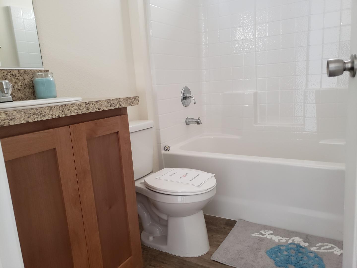 55 San Juan Grade Road, Unit 49 Salinas, CA 93906 - Photo 8 of 14 a bathroom with a granite countertop toilet sink and shower
