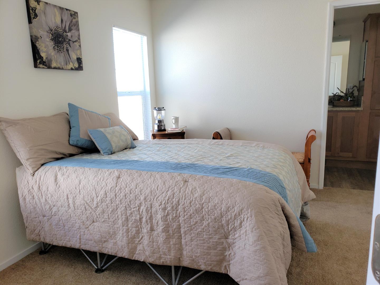 55 San Juan Grade Road, Unit 49 Salinas, CA 93906 - Photo 10 of 14 a bedroom with a bed and wall painting