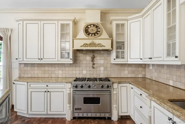 a stove top oven sitting inside of a kitchen