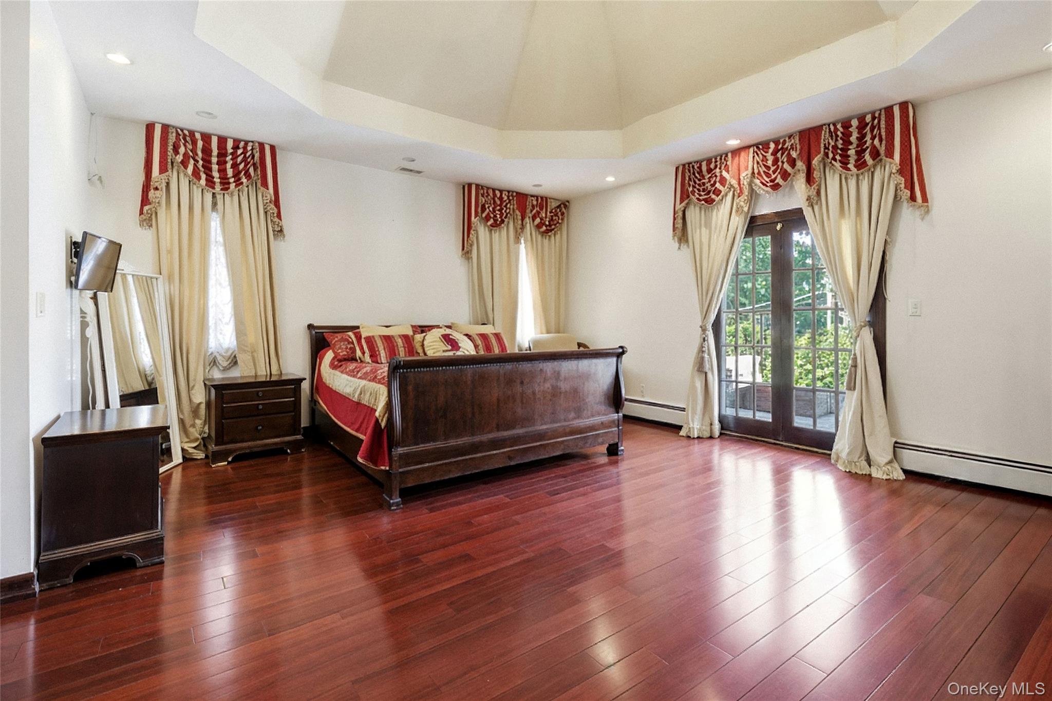 186-31 Radnor Road Queens, NY 11432 - Photo 7 of 11 a living room with a bed furniture and a window