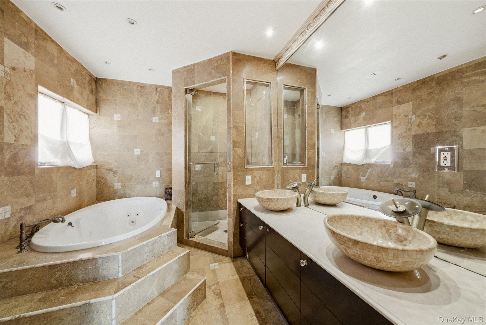 186-31 Radnor Road Queens, NY 11432 - Photo 8 of 11 a bathroom with a double vanity sink toilet mirror and bathtub