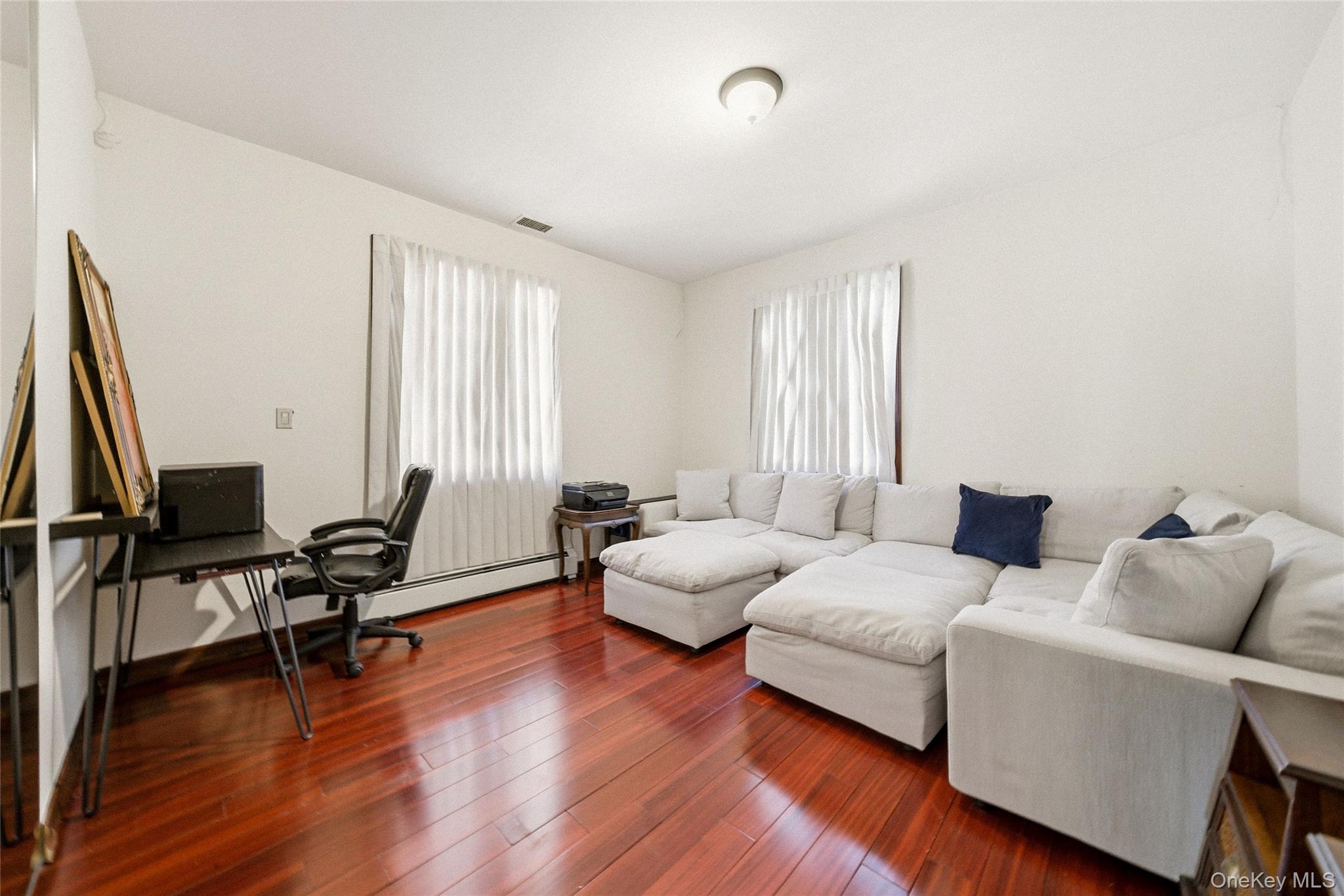186-31 Radnor Road Queens, NY 11432 - Photo 10 of 11 a living room with furniture and wooden floor