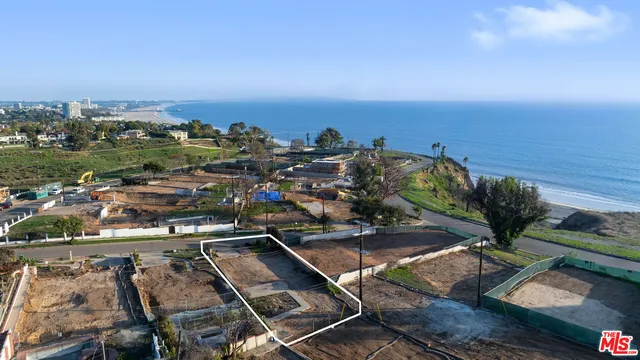 a view of a street with a cars parked on the road