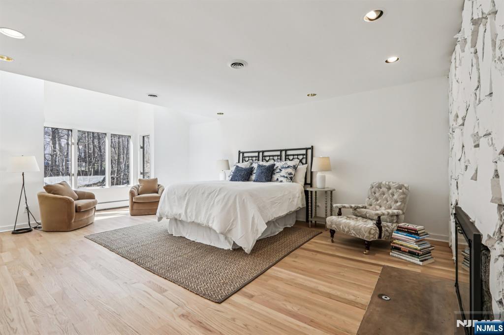 11 Carlough Road Upper Saddle River, NJ 07458 - Photo 29 of 41 a bedroom with a bed and wooden floor
