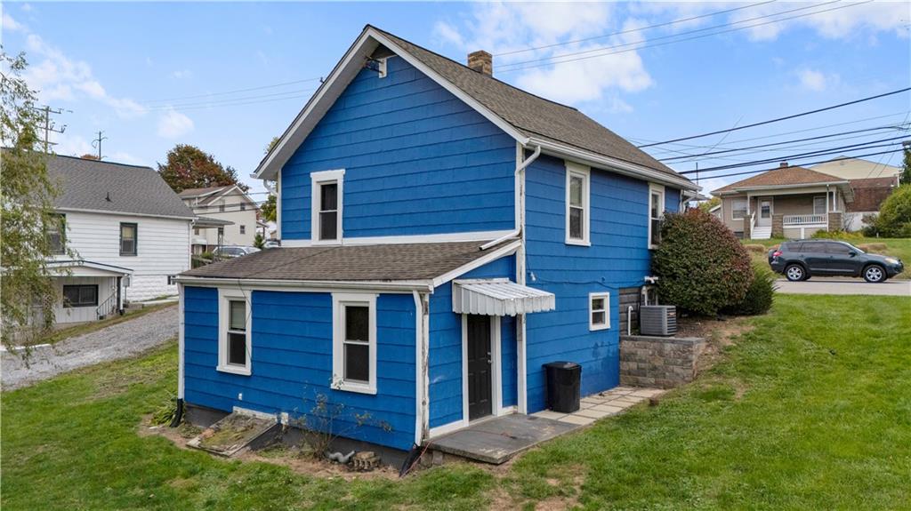 2067 Brodhead Road Aliquippa, PA 15001 - Photo 4 of 8 a view of a house with a yard plants and large tree