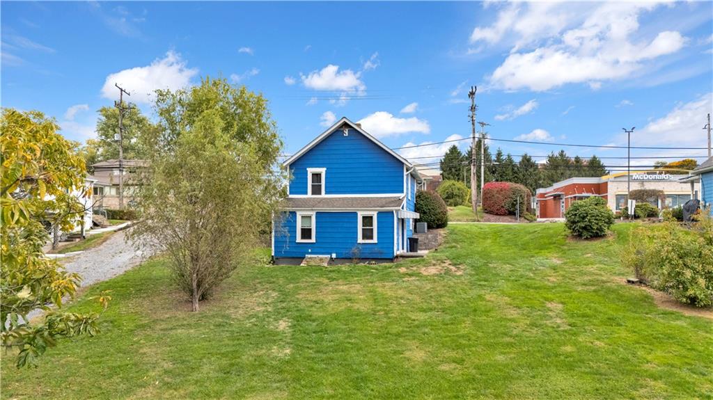 2067 Brodhead Road Aliquippa, PA 15001 - Photo 6 of 8 a view of a house with a yard and potted plants