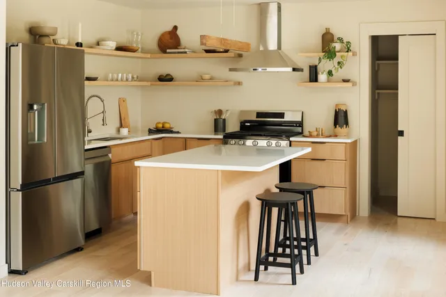 a kitchen with stainless steel appliances a refrigerator and a stove