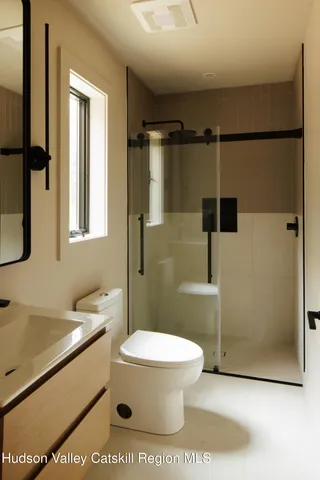 a bathroom with a toilet a sink and shower