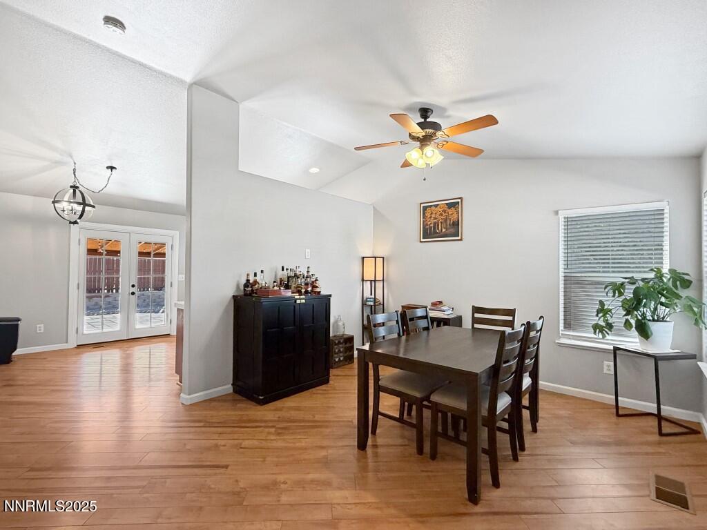 2119 Fort Bridger Road Fernley, NV 89408 - Photo 2 of 18 a view of a dining room with furniture and wooden floor
