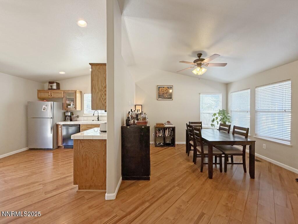 2119 Fort Bridger Road Fernley, NV 89408 - Photo 4 of 18 a view of a dining room with furniture and wooden floor