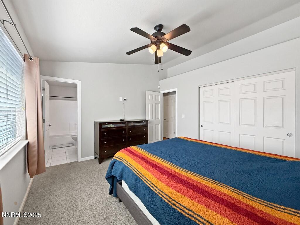 2119 Fort Bridger Road Fernley, NV 89408 - Photo 8 of 18 a bedroom with a bed and a chandelier