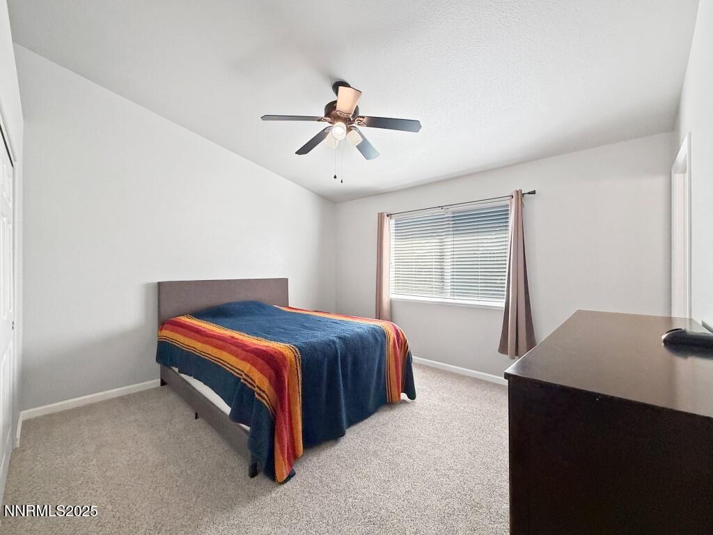 2119 Fort Bridger Road Fernley, NV 89408 - Photo 9 of 18 a bedroom with a bed and window